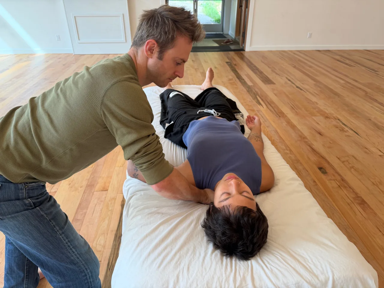 John supporting a client’s shoulder during Sensory Repatterning.
