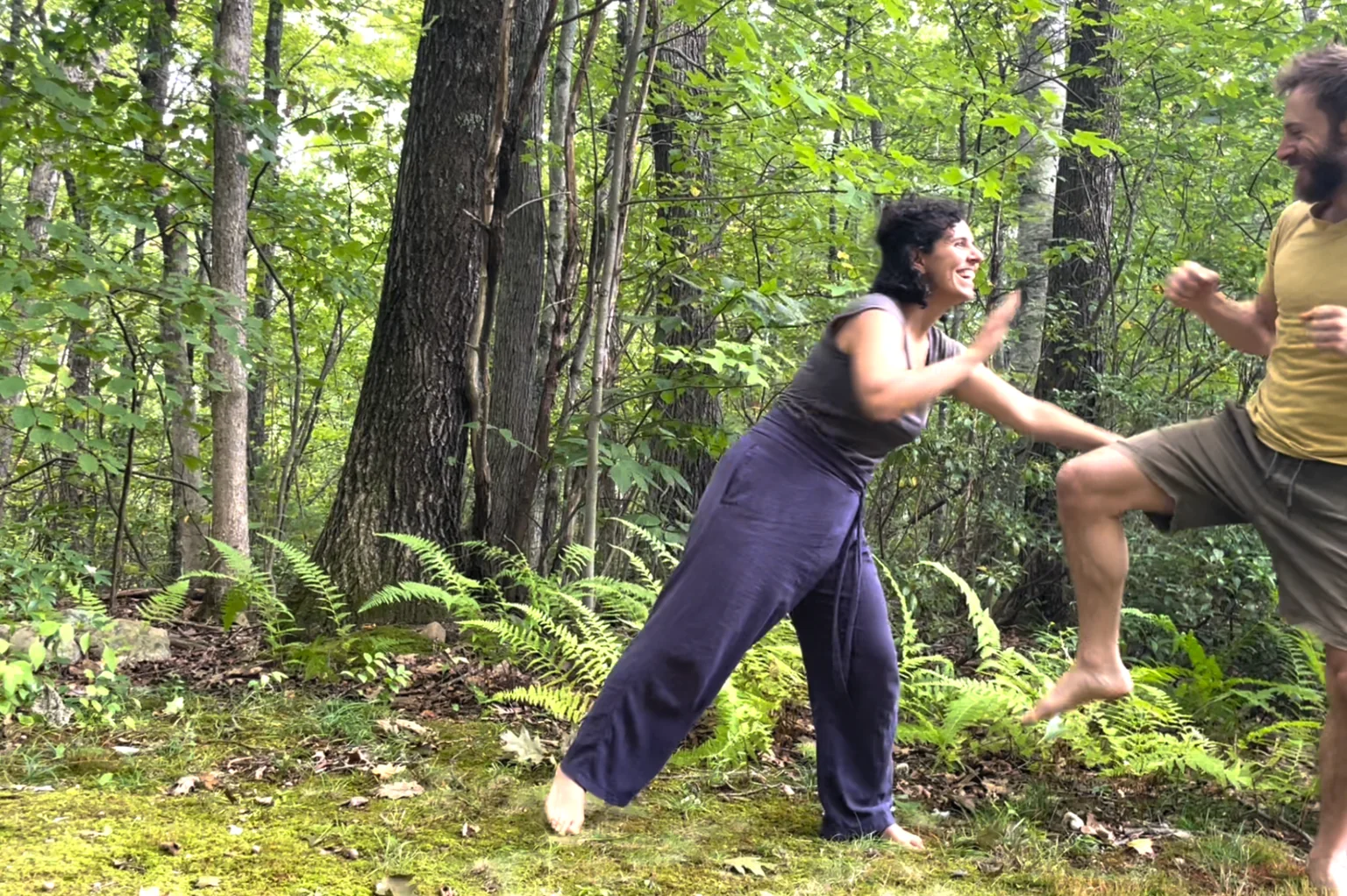 John and a partner playing with movement together outdoors.
